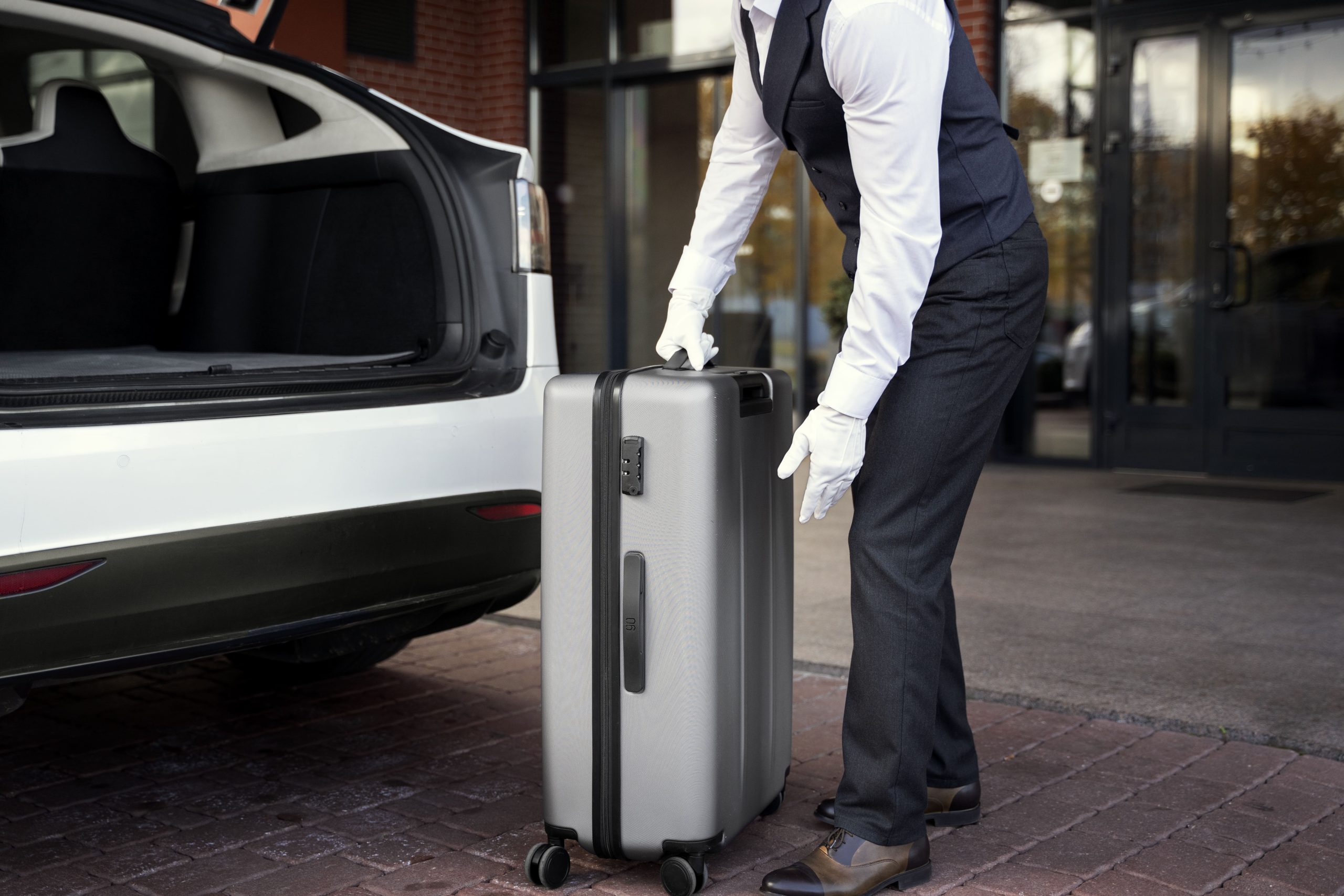 side-view-valet-holding-baggage
